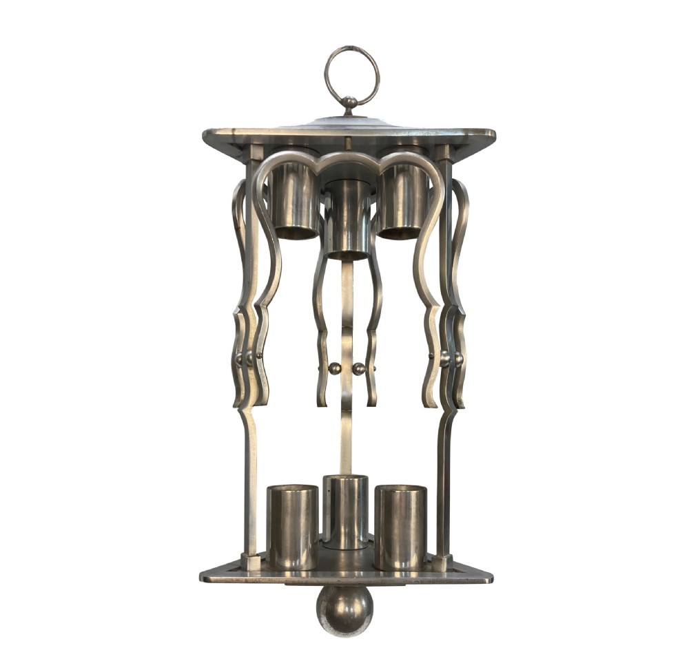 An Art Deco steel hanging lantern fixture featuring geometric metalwork, cylindrical socket covers, a top loop for suspension, and a spherical bottom finial.