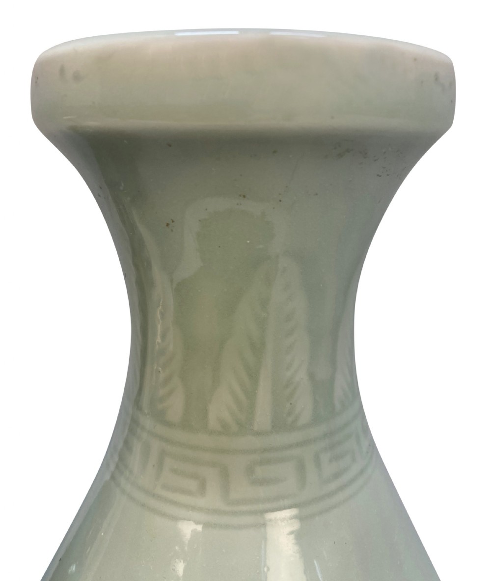 A trio of Japanese ceramic vases featuring a cream crackle-glazed vase, a small turquoise enamel vase with metal mounts, and a tall pale green celadon vase with carved lotus motifs. View V