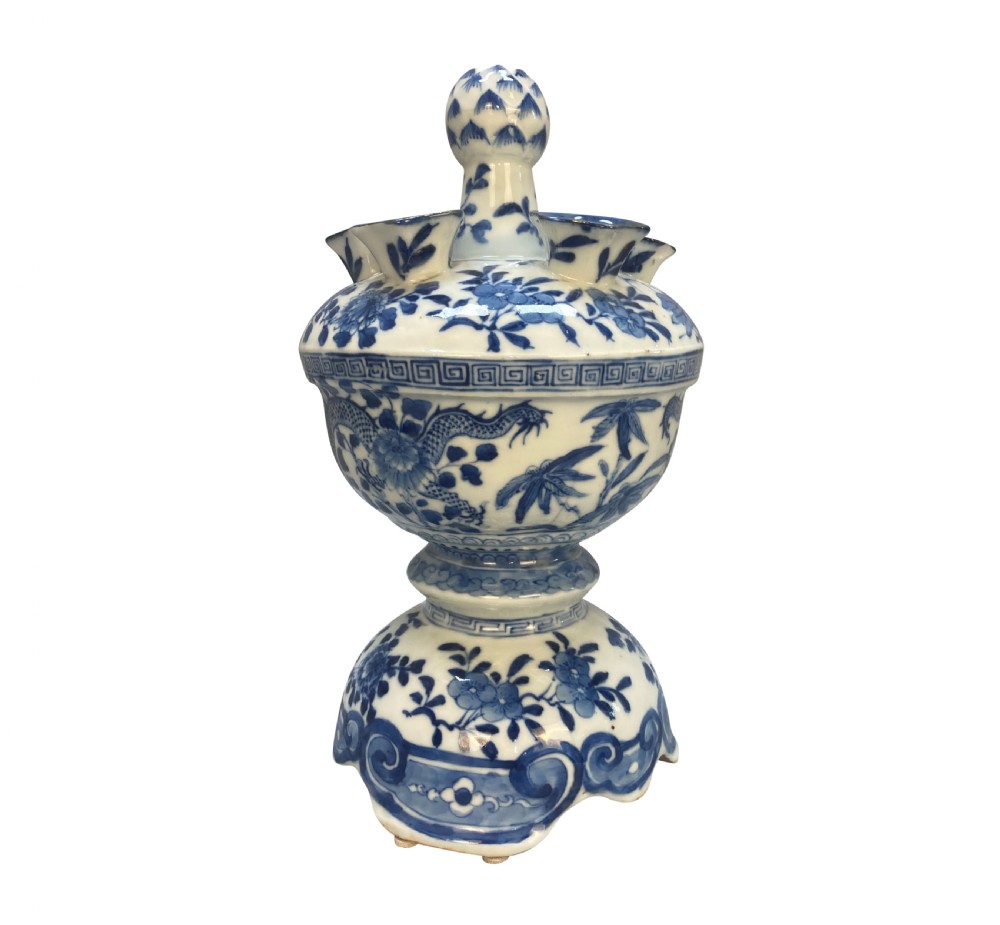 A blue and white Chinese porcelain tulipiere featuring floral and dragon underglaze motifs with multiple spout apertures surrounding a central finial.