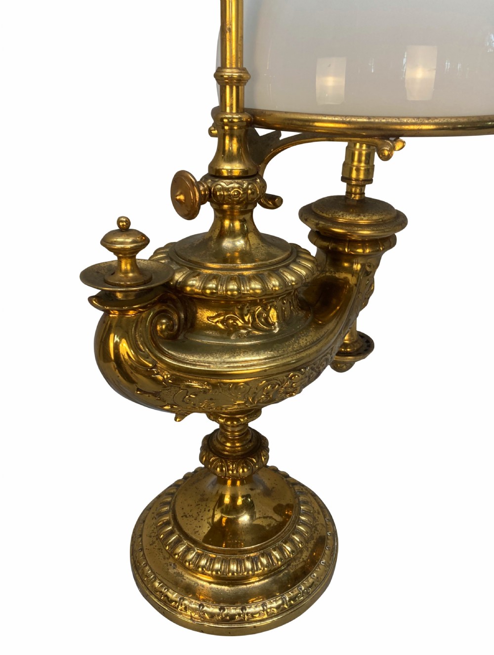 A pair of ornate 19th-century brass desk lamps featuring elaborate cast detail, tall central adjustment poles with ring finials, and white domed glass shades. View VI