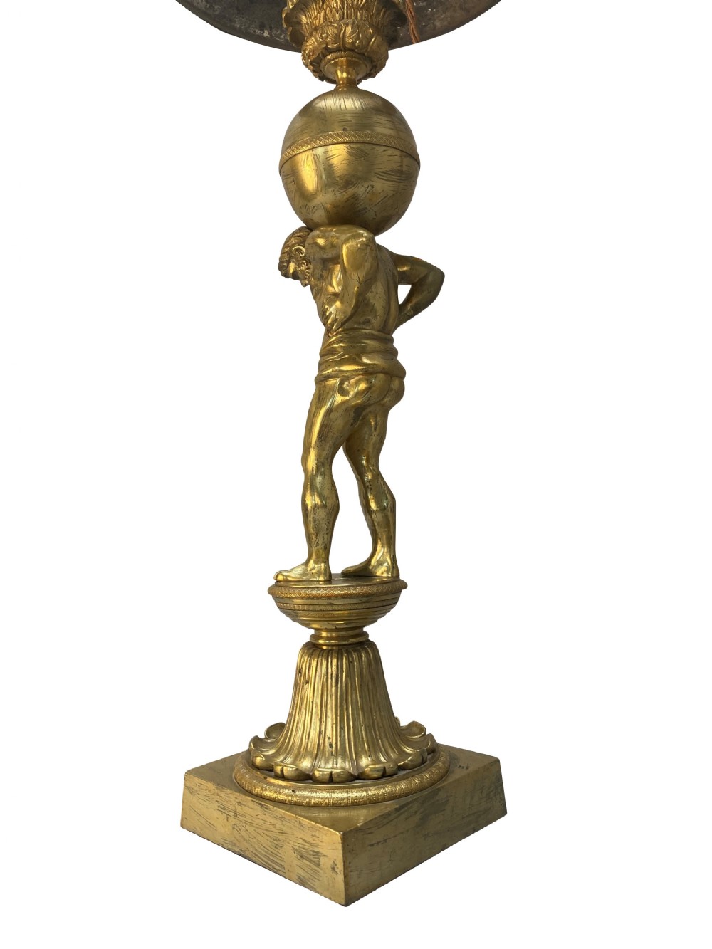 An English Regency gilt-bronze table lamp featuring a figure of Atlas supporting a sphere beneath a frosted glass dome shade. View X