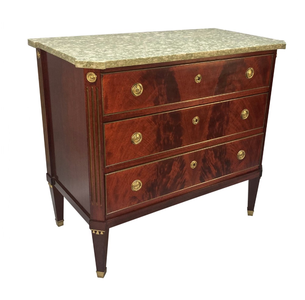 A 19th-century Russian flame mahogany commode featuring three drawers with brass ring handles, fluted corner pilasters, square tapered legs, and a pale green marble top. View II
