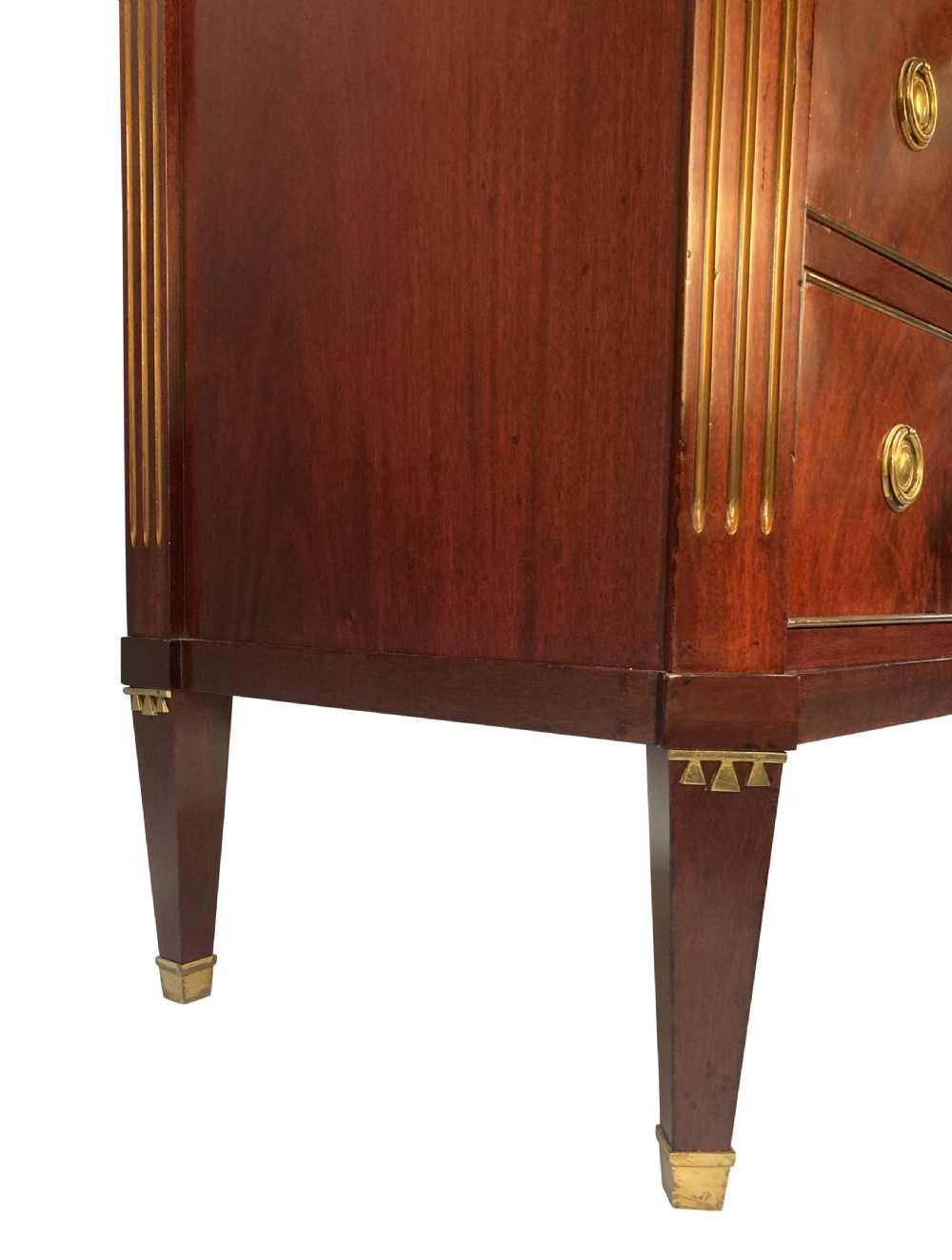 A 19th-century Russian flame mahogany commode featuring three drawers with brass ring handles, fluted corner pilasters, square tapered legs, and a pale green marble top. View V