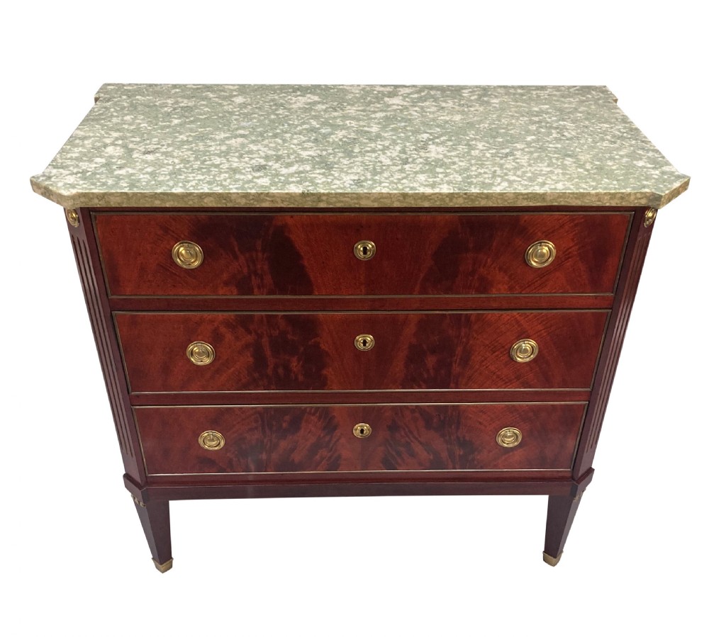 A 19th-century Russian flame mahogany commode featuring three drawers with brass ring handles, fluted corner pilasters, square tapered legs, and a pale green marble top. View VII