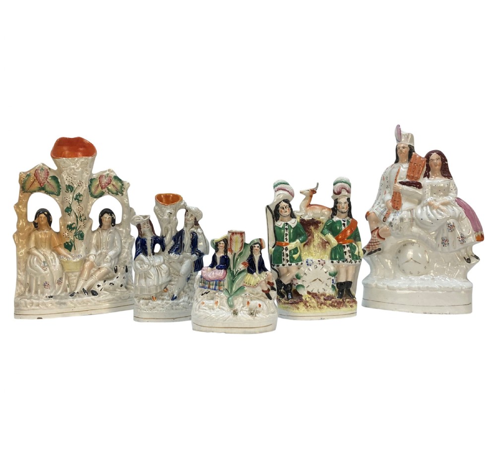 A set of five Victorian Staffordshire flatback earthenware figures depicting couples, hunters, and spill vases with colourful hand-painted enamel glazes.