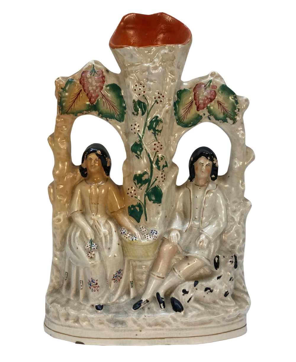 A set of five Victorian Staffordshire flatback earthenware figures depicting couples, hunters, and spill vases with colourful hand-painted enamel glazes. View II