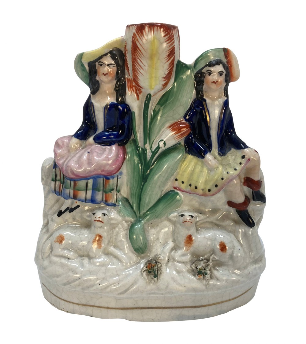 A set of five Victorian Staffordshire flatback earthenware figures depicting couples, hunters, and spill vases with colourful hand-painted enamel glazes. View V