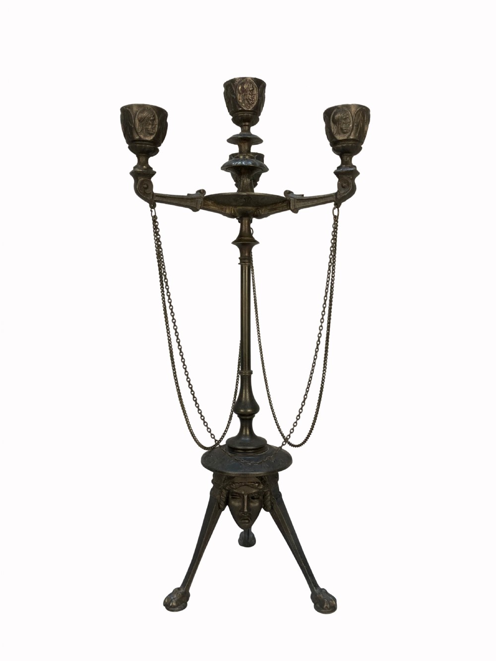 A pair of 19th-century dark bronze three-light candelabra with draped metal chains, classical face masks, and tripod bases ending in claw feet. View II