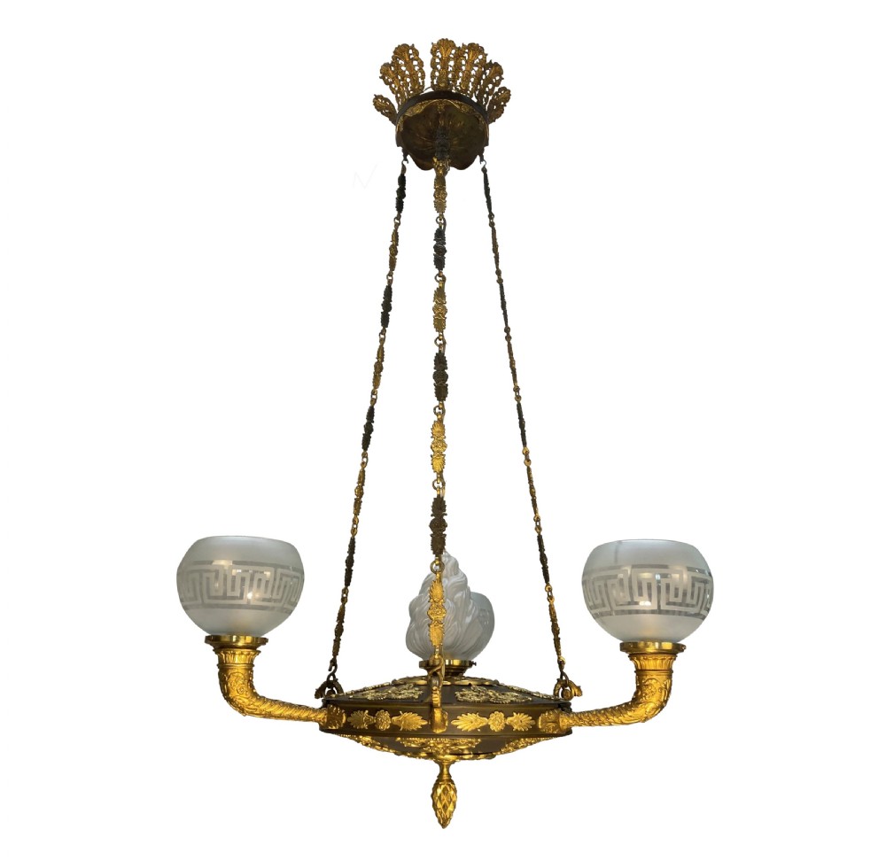 A Regency period gilt and patinated bronze colza hanging light featuring etched frosted glass shades with Greek key motifs.