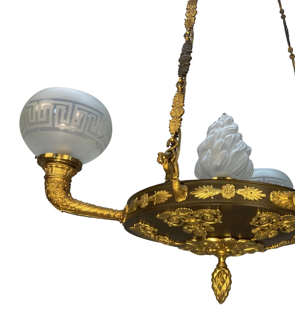 A Regency period gilt and patinated bronze colza hanging light featuring etched frosted glass shades with Greek key motifs. View V