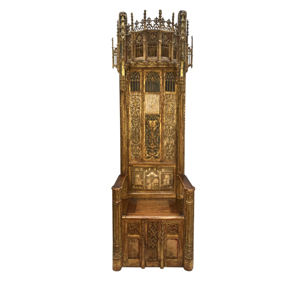 A tall 15th-century carved oak ecclesiastical throne featuring elaborate Gothic tracery, a decorative canopy, and gilded details.