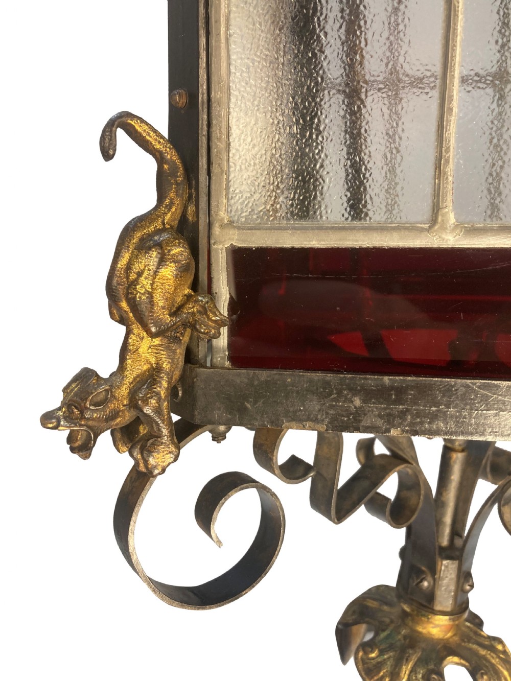 A 19th-century Gothic Revival hanging brass lantern featuring paned glass, ruby red glass borders, ornate crocketed pinnacles, and scrollwork. View IV