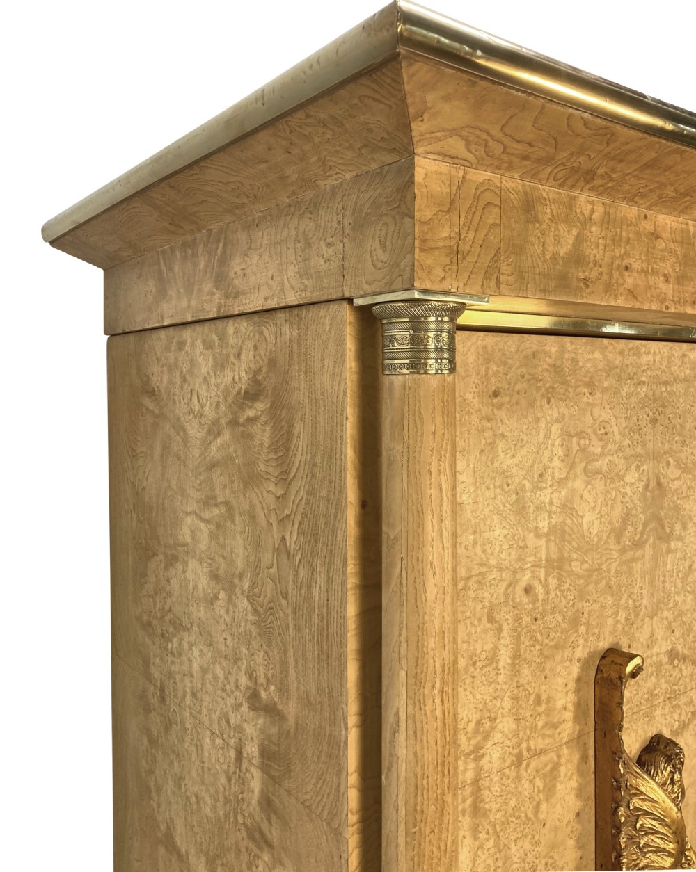 A large two-door Swedish Empire Revival cupboard crafted in light birds eye maple wood featuring gilt winged sphinx mounts and brass trim. View V