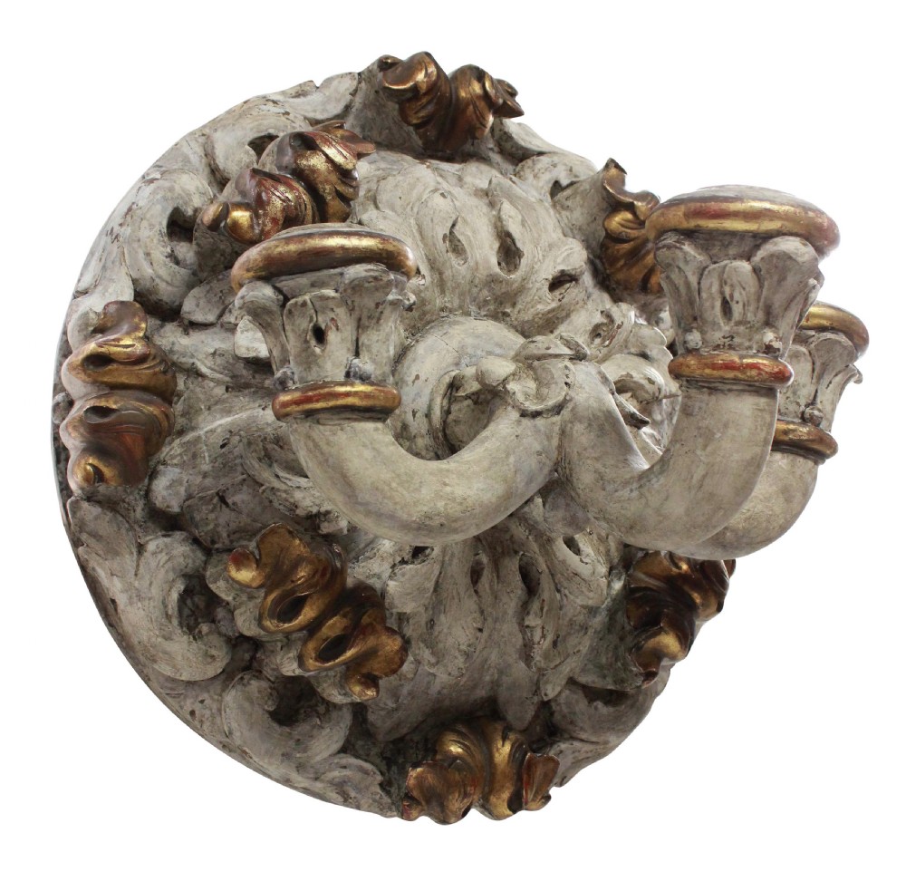 A 19th-century carved wooden three-branch wall sconce with detailed acanthus leaf decoration, distressed grey paint, and gilded accents. View II