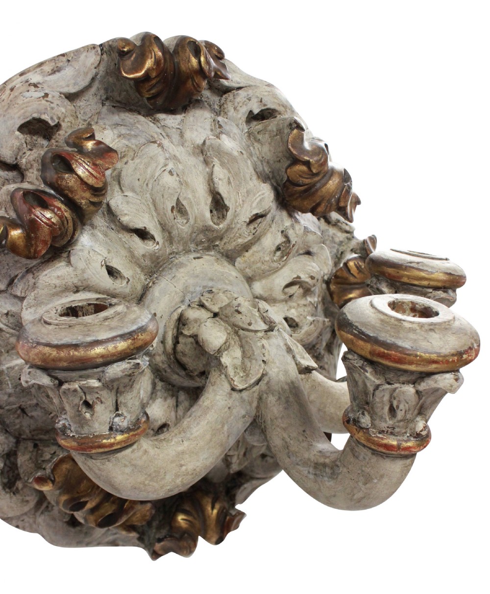 A 19th-century carved wooden three-branch wall sconce with detailed acanthus leaf decoration, distressed grey paint, and gilded accents. View IV