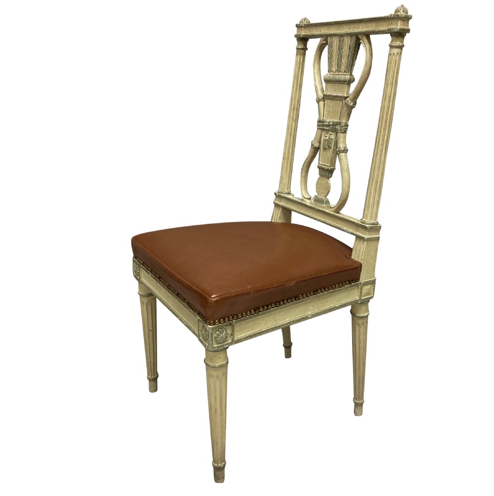 A set of six Louis XVI style cream painted side chairs featuring open carved backs with urn motifs and brown leather upholstered seats with stud detailing. View IV
