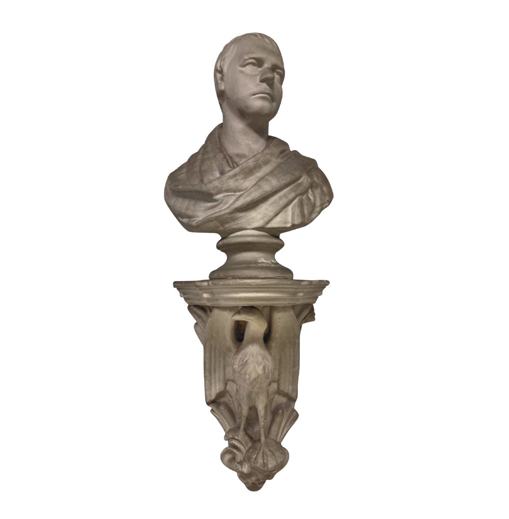 An off-white plaster classical portrait bust of Sir Walter Scott set atop a decorative wall bracket decorated with an eagle corbel.