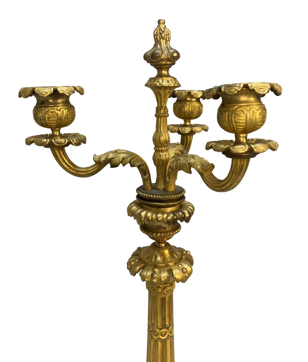 A pair of French Charles X gilt bronze three-light candelabra with scrolling acanthus leaves and fluted columns. View VII