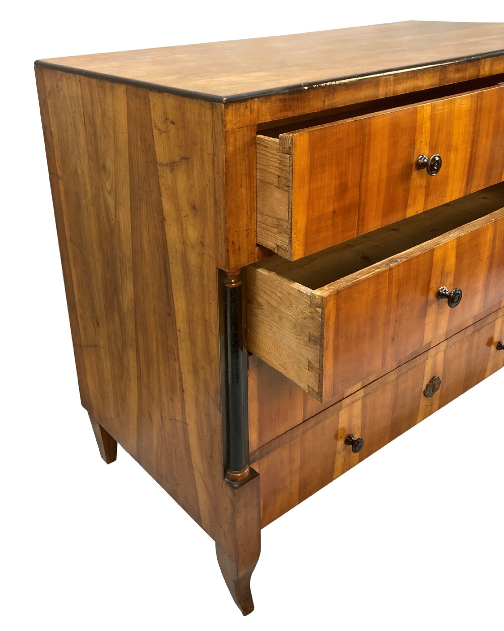An early nineteenth-century Biedermeier chest of four drawers crafted from figured timber veneer, flanked by ebonised side columns and supported by tapered front legs. View VIII