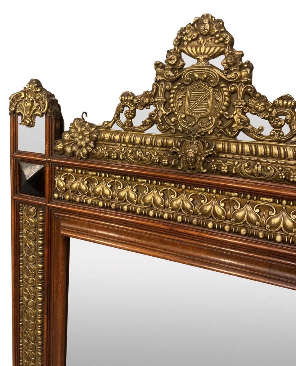 A 19th-century Flemish rectangular wall mirror featuring embossed brass panels, decorative cresting, and dark wooden moulding. View IV