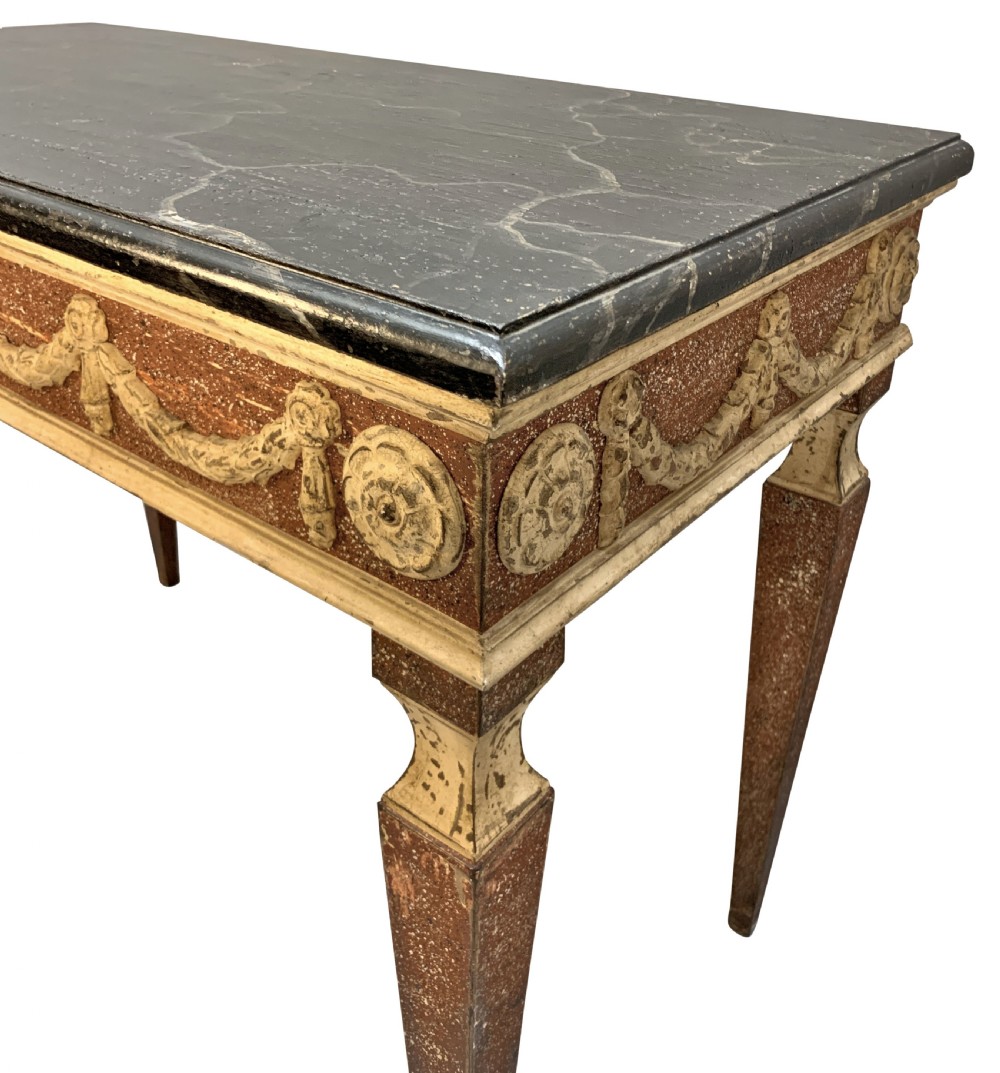 An 18th-century Italian Neoclassical console table featuring a dark marble top, square tapered legs, and a painted apron decorated with carved draped garlands. View IV