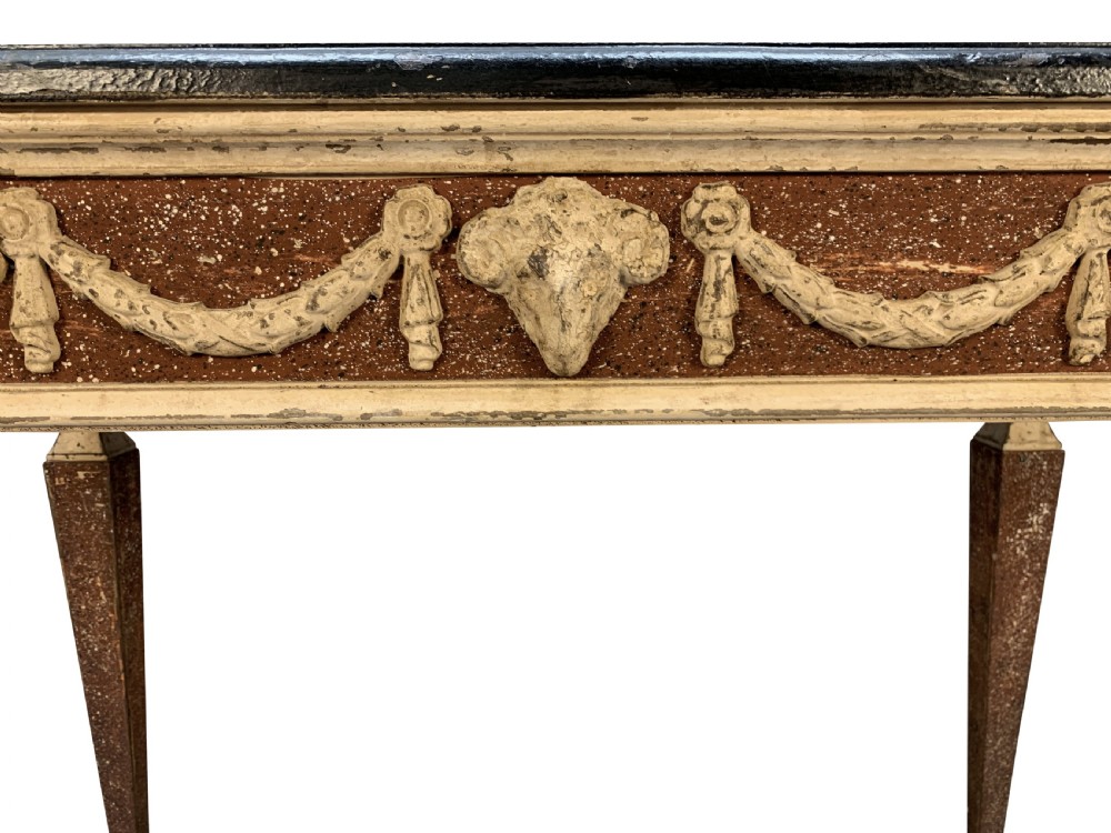 An 18th-century Italian Neoclassical console table featuring a dark marble top, square tapered legs, and a painted apron decorated with carved draped garlands. View VI