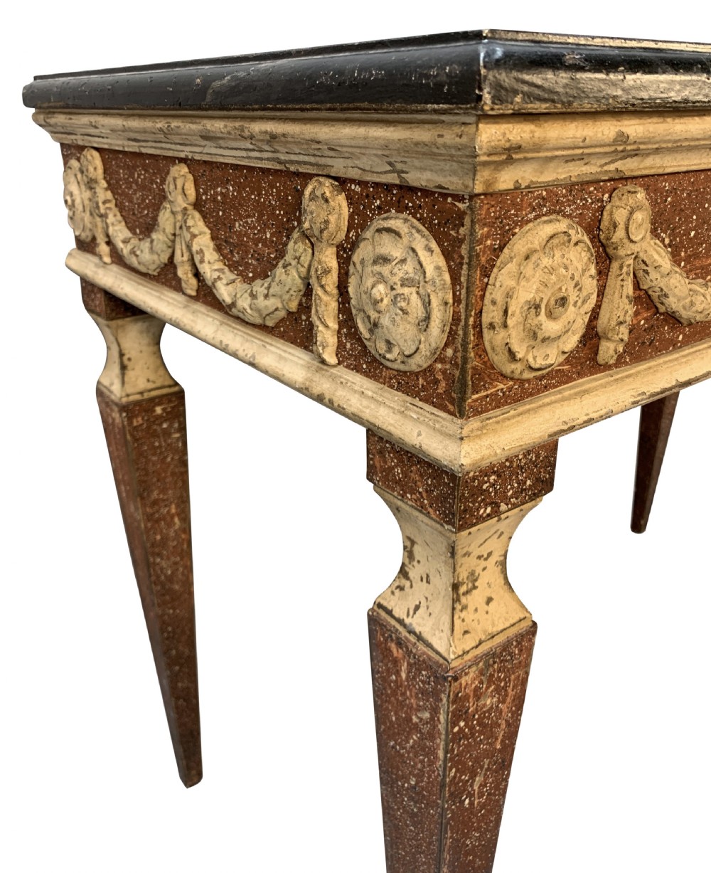 An 18th-century Italian Neoclassical console table featuring a dark marble top, square tapered legs, and a painted apron decorated with carved draped garlands. View VII