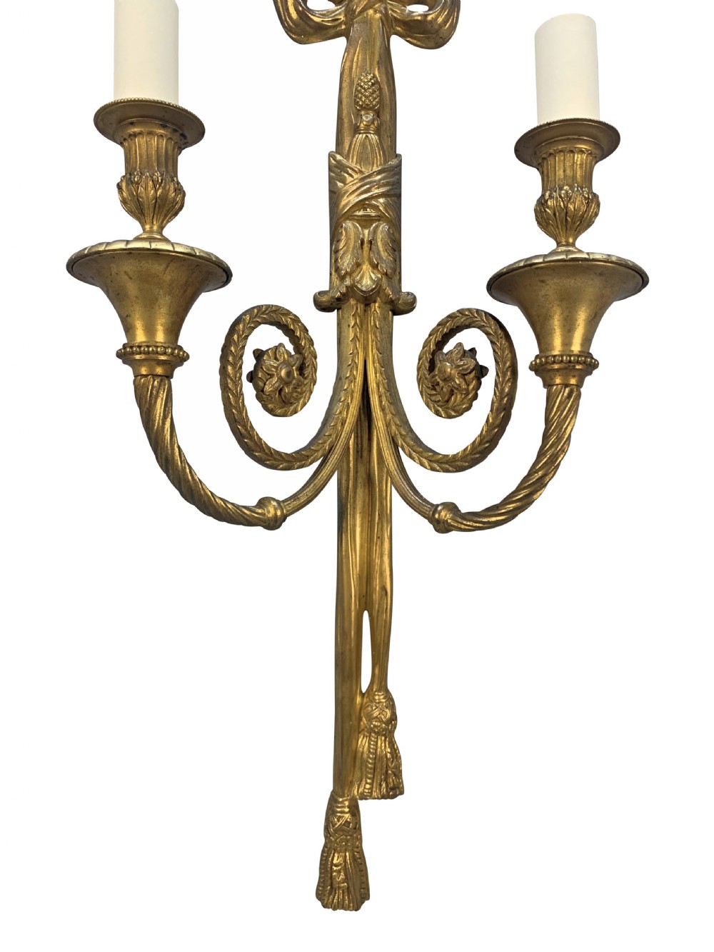 A pair of gilt bronze two-arm wall sconces featuring ribbon bow crests, tassel drops, and candle sockets. View III