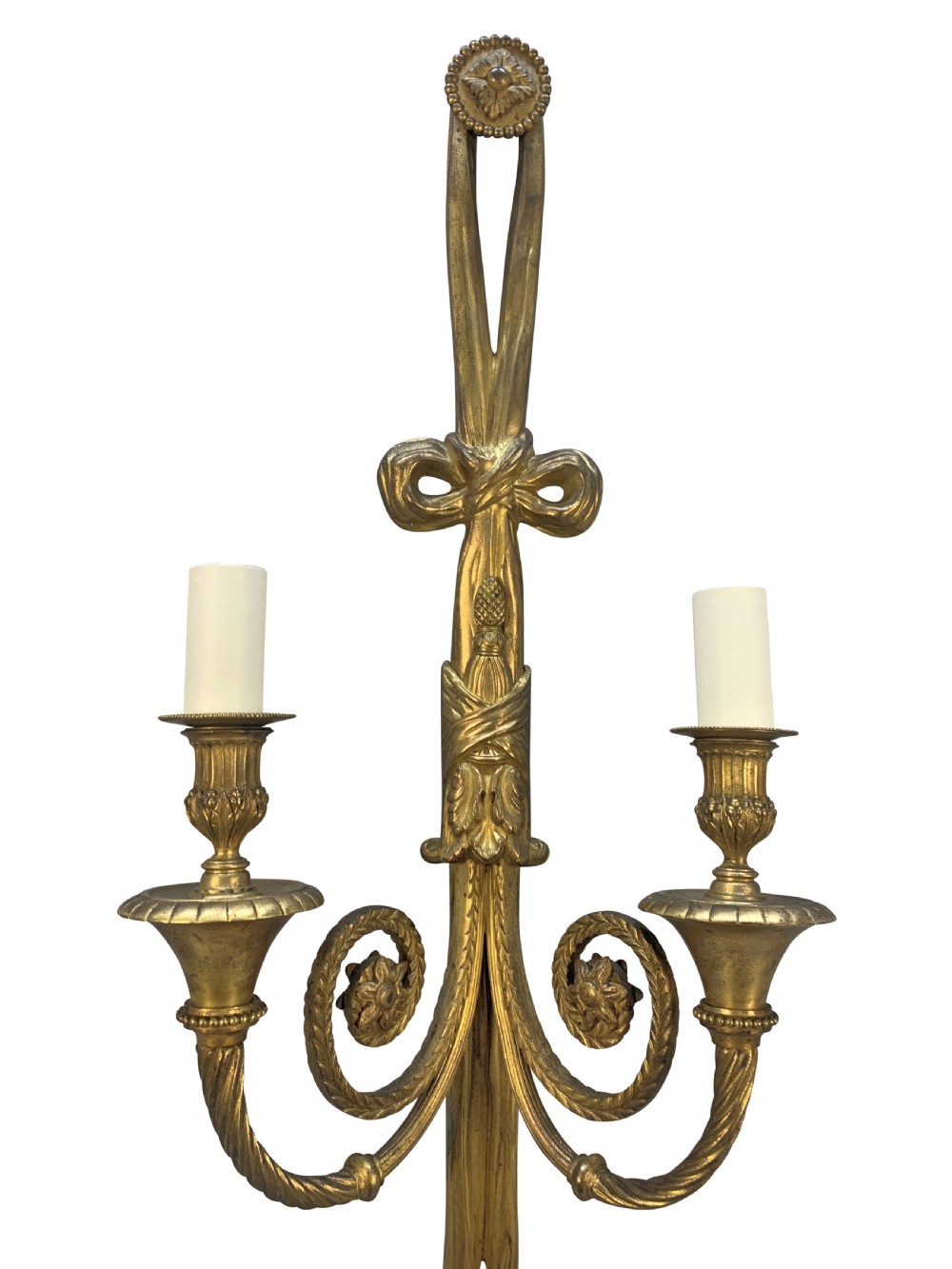A pair of gilt bronze two-arm wall sconces featuring ribbon bow crests, tassel drops, and candle sockets. View VI