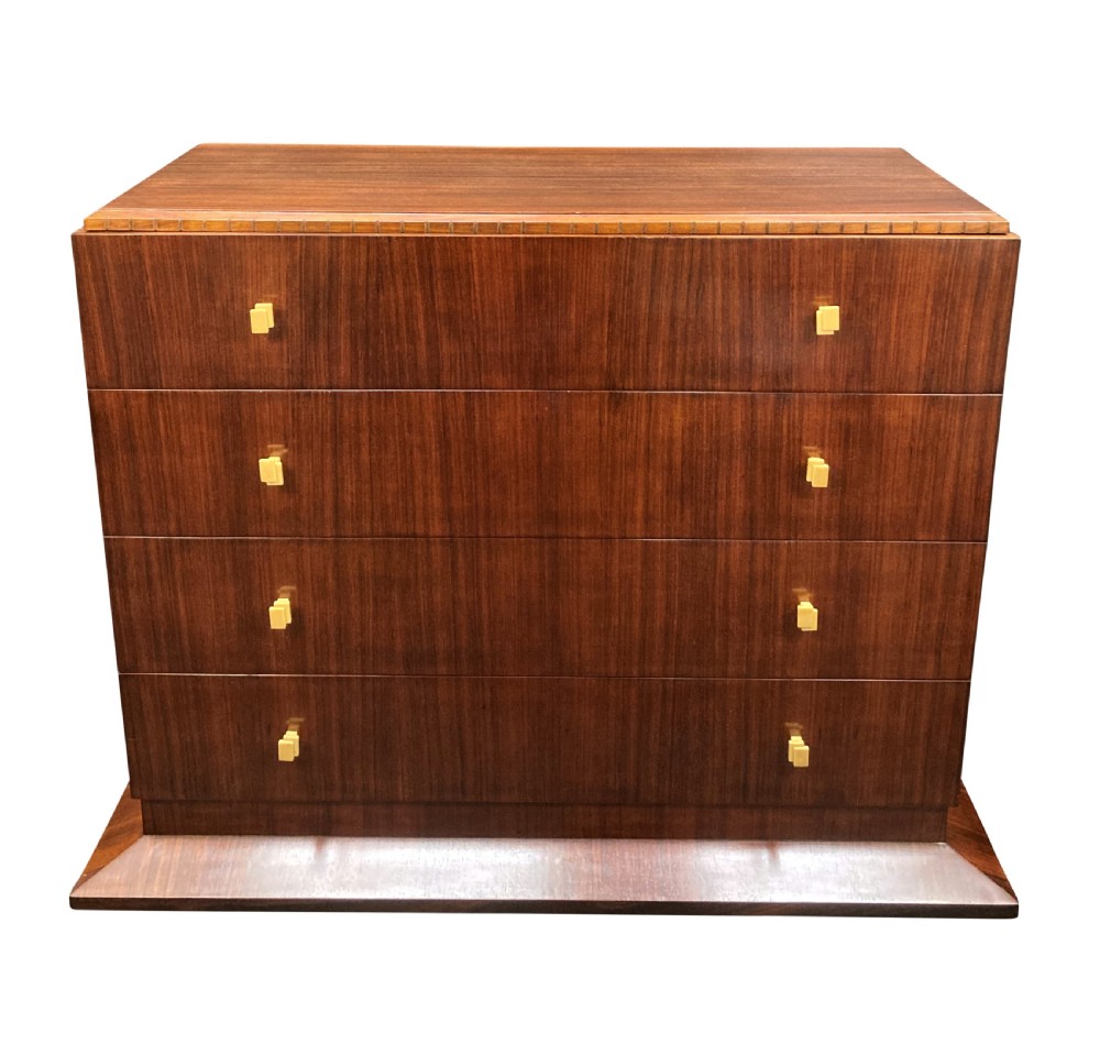 An Art Deco dark wood commode featuring four stacked drawers with cream-coloured Bakelite handles resting on a stepped plinth base. View II