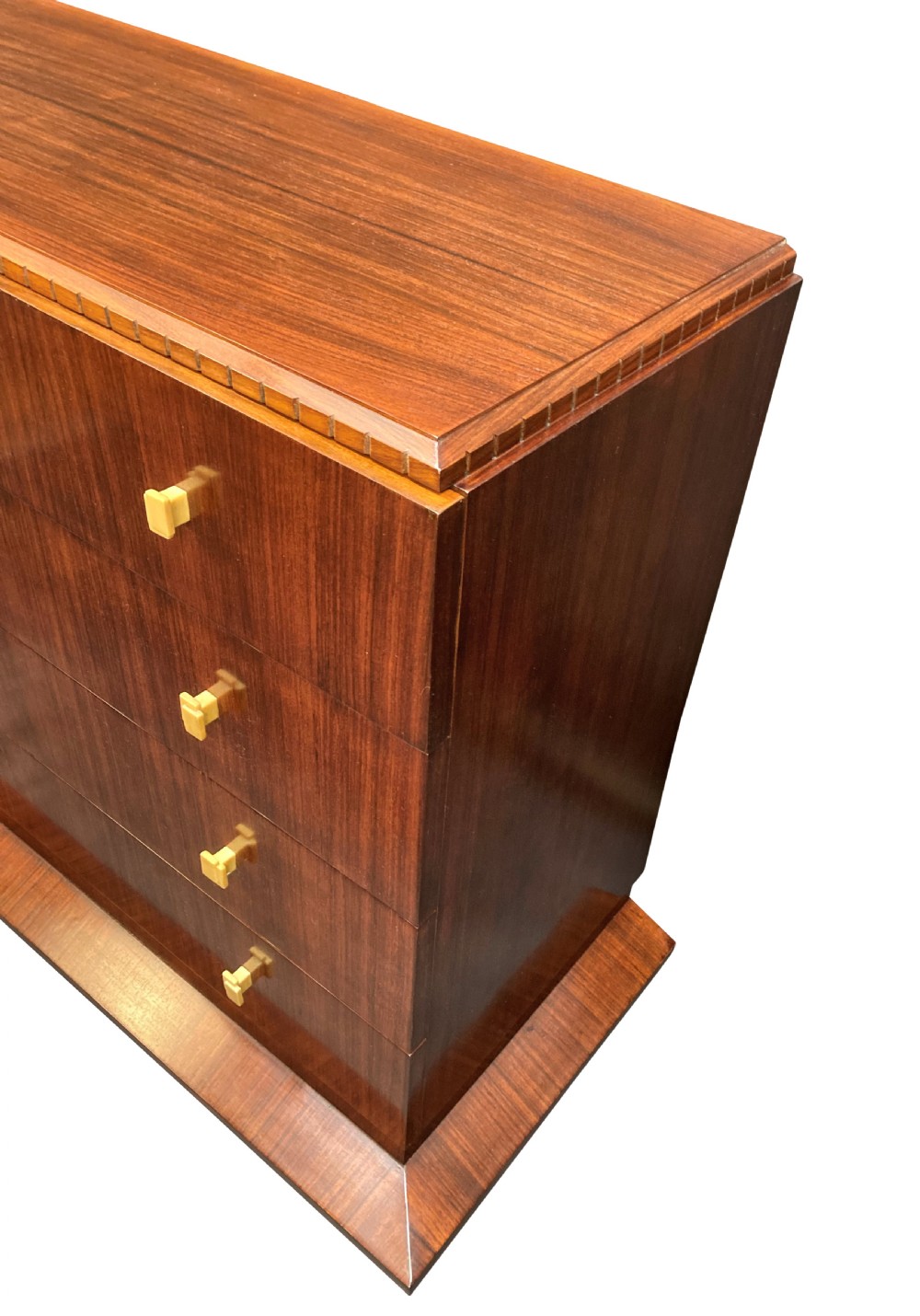 An Art Deco dark wood commode featuring four stacked drawers with cream-coloured Bakelite handles resting on a stepped plinth base. View VII