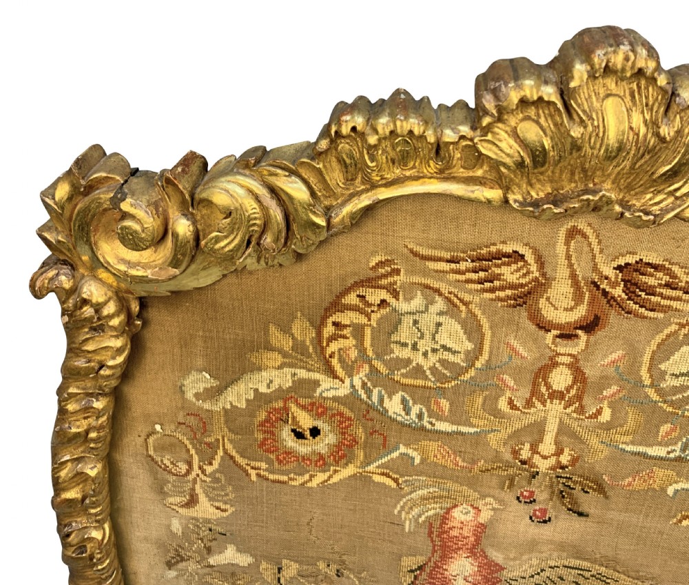 A George III giltwood fire screen with a carved gold frame and a central needlepoint panel depicting a bird and floral motifs. View V