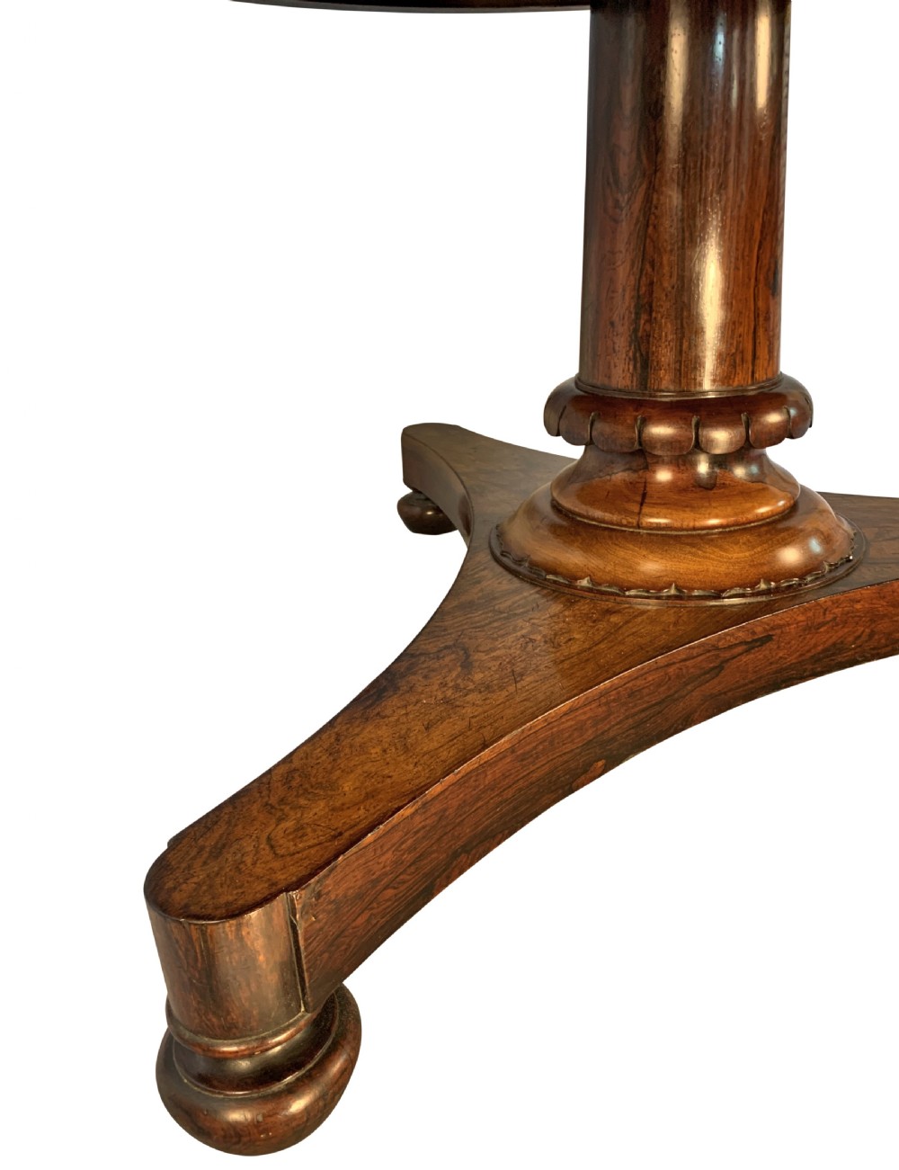 A circular William IV rosewood tilt-top centre table featuring a book-matched veneer top, turned column, and triform base on bun feet. View VI