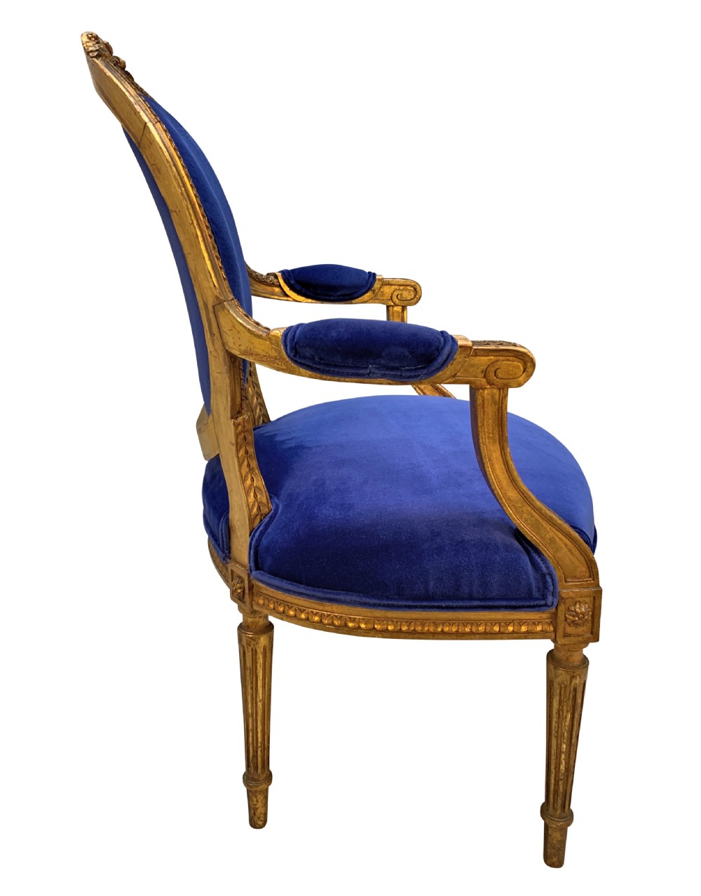 A set of four Louis XVI style armchairs featuring carved giltwood frames with oval medallion backs and royal blue velvet upholstery. View IV