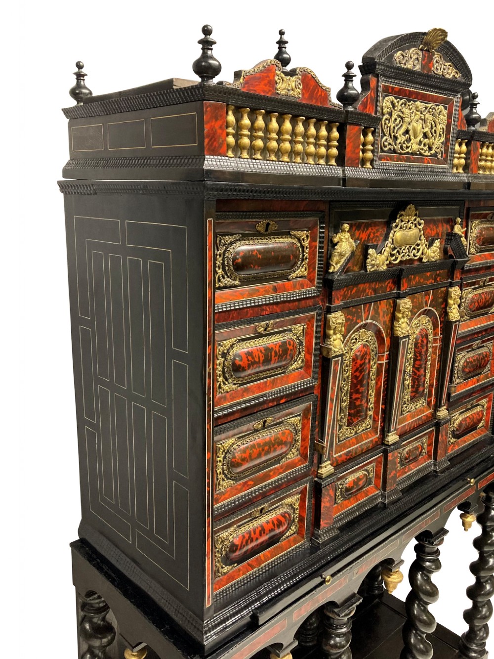 A 17th-century Flemish architectural cabinet on stand featuring red tortoiseshell veneered drawer fronts, gilt bronze mounts, and six ebonised barley-twist legs. View V