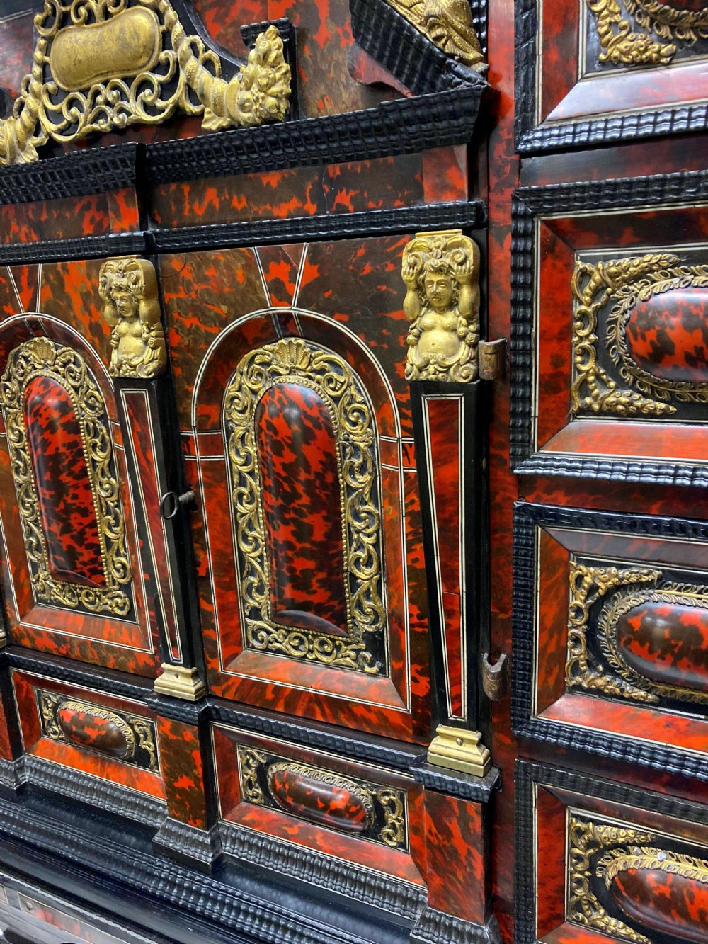 A 17th-century Flemish architectural cabinet on stand featuring red tortoiseshell veneered drawer fronts, gilt bronze mounts, and six ebonised barley-twist legs. View IX