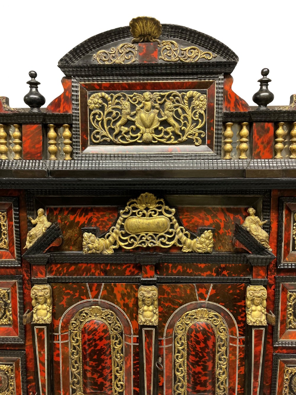 A 17th-century Flemish architectural cabinet on stand featuring red tortoiseshell veneered drawer fronts, gilt bronze mounts, and six ebonised barley-twist legs. View XIV