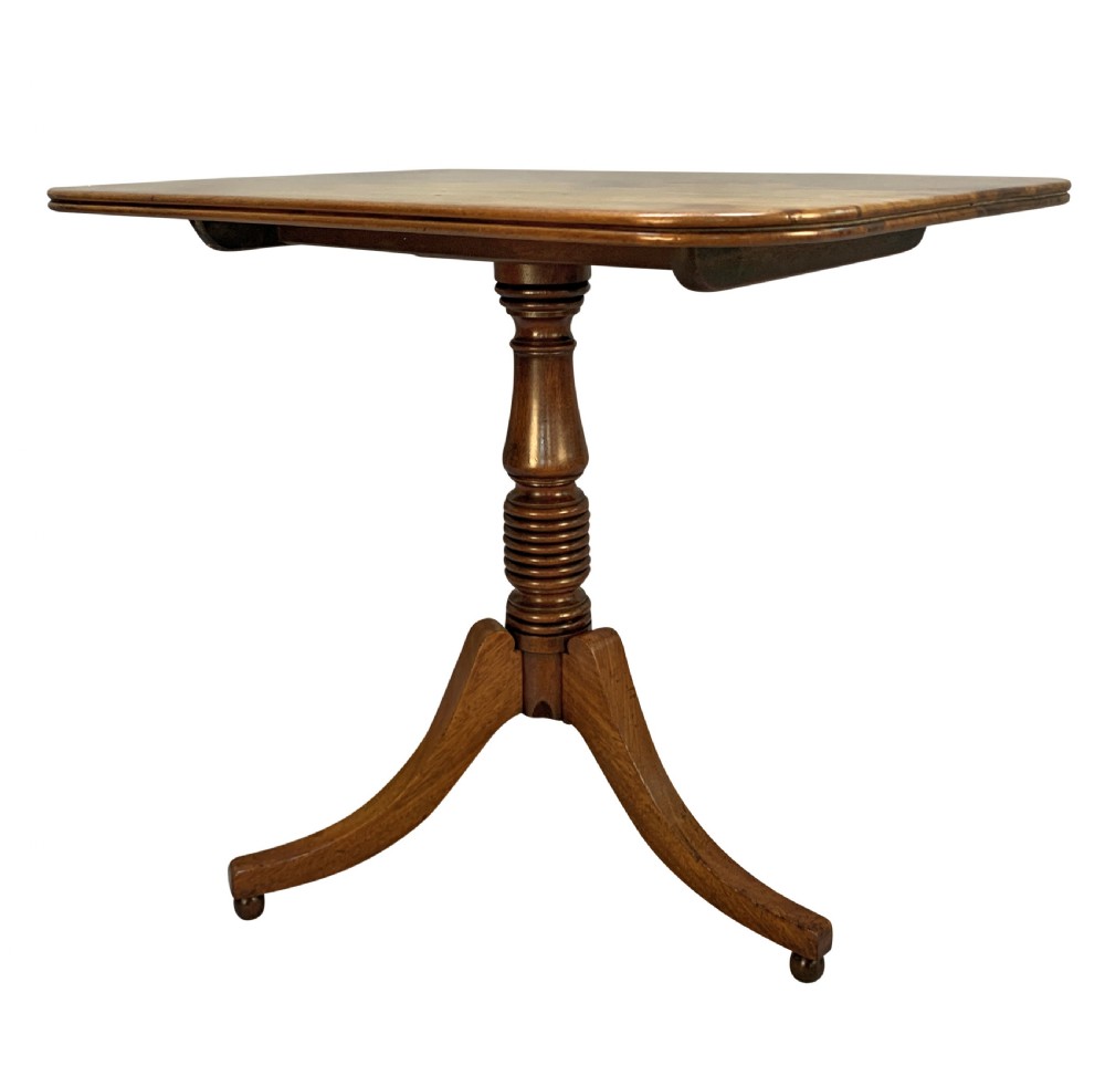A George III mahogany side table featuring a rounded rectangular tilt-top on a turned pedestal with three splayed tripod legs. View III