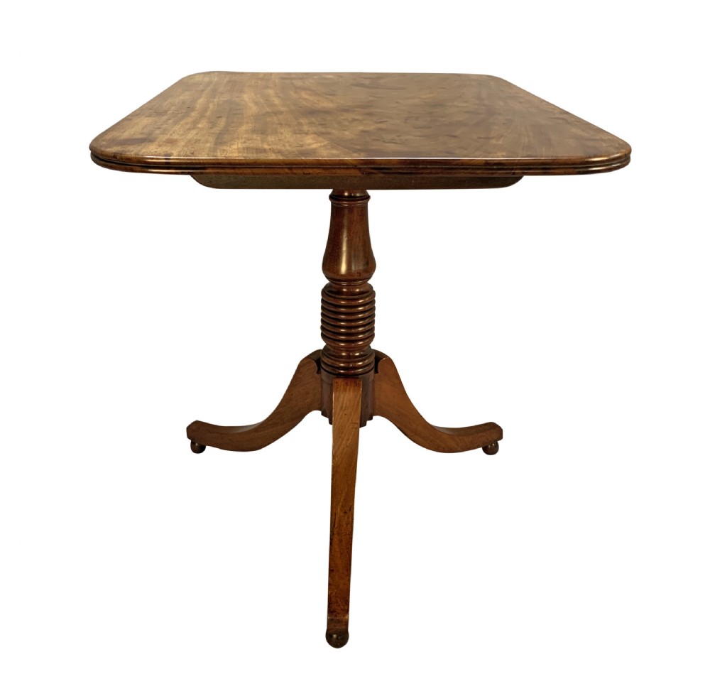 A George III mahogany side table featuring a rounded rectangular tilt-top on a turned pedestal with three splayed tripod legs. View IV