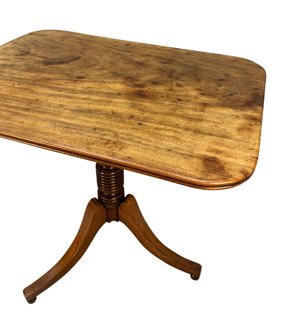 A George III mahogany side table featuring a rounded rectangular tilt-top on a turned pedestal with three splayed tripod legs. View VI
