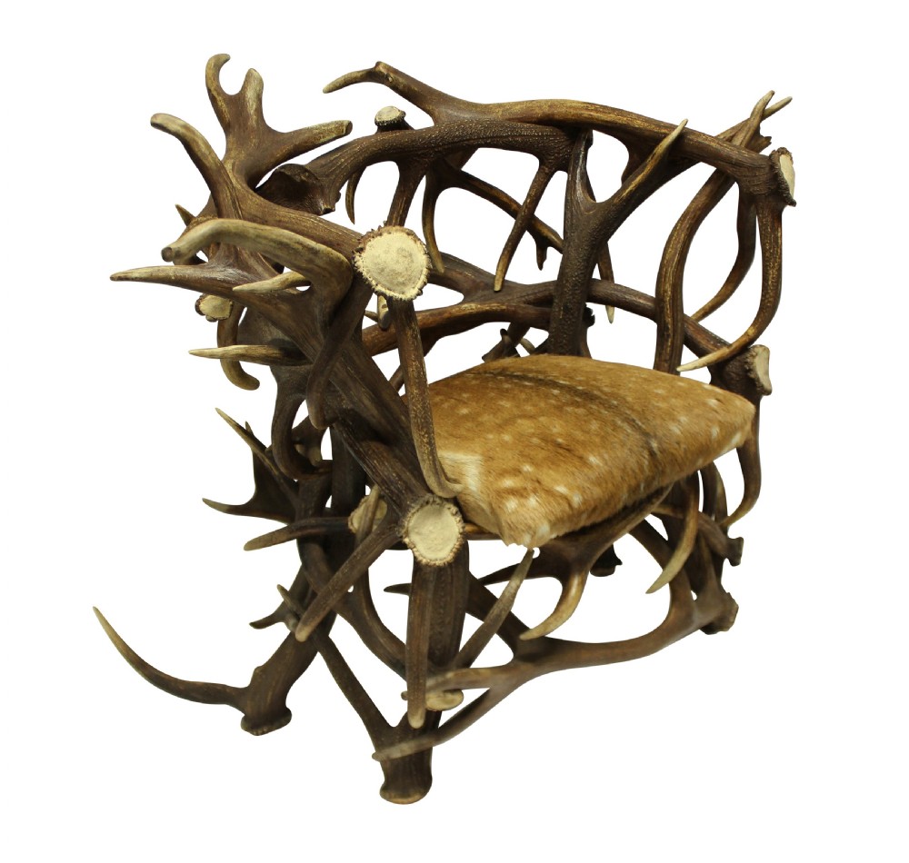 A pair of Edwardian armchairs constructed from interlocking natural antlers with spotted deer hide seat cushions. View IV