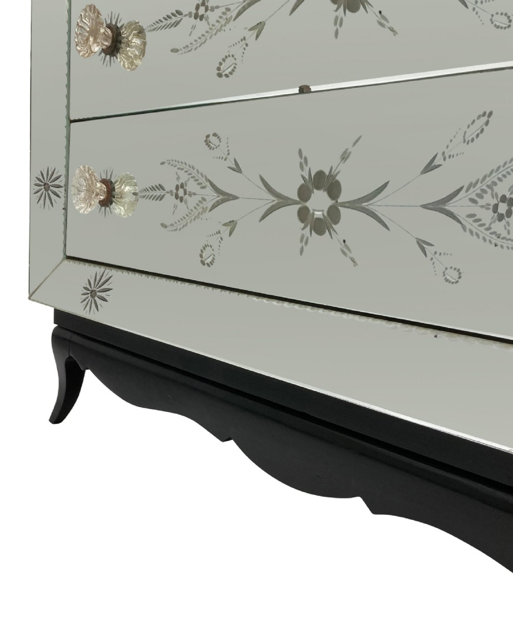 A 1930s French Art Deco three-drawer chest clad entirely in etched mirrored glass with starburst corner motifs and a black wooden base. View VIII