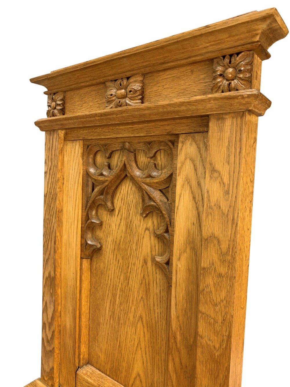 A set of four solid English oak hall chairs featuring carved Gothic arch panels on the backrests, flat solid seats, and straight legs with H-stretchers. View VII
