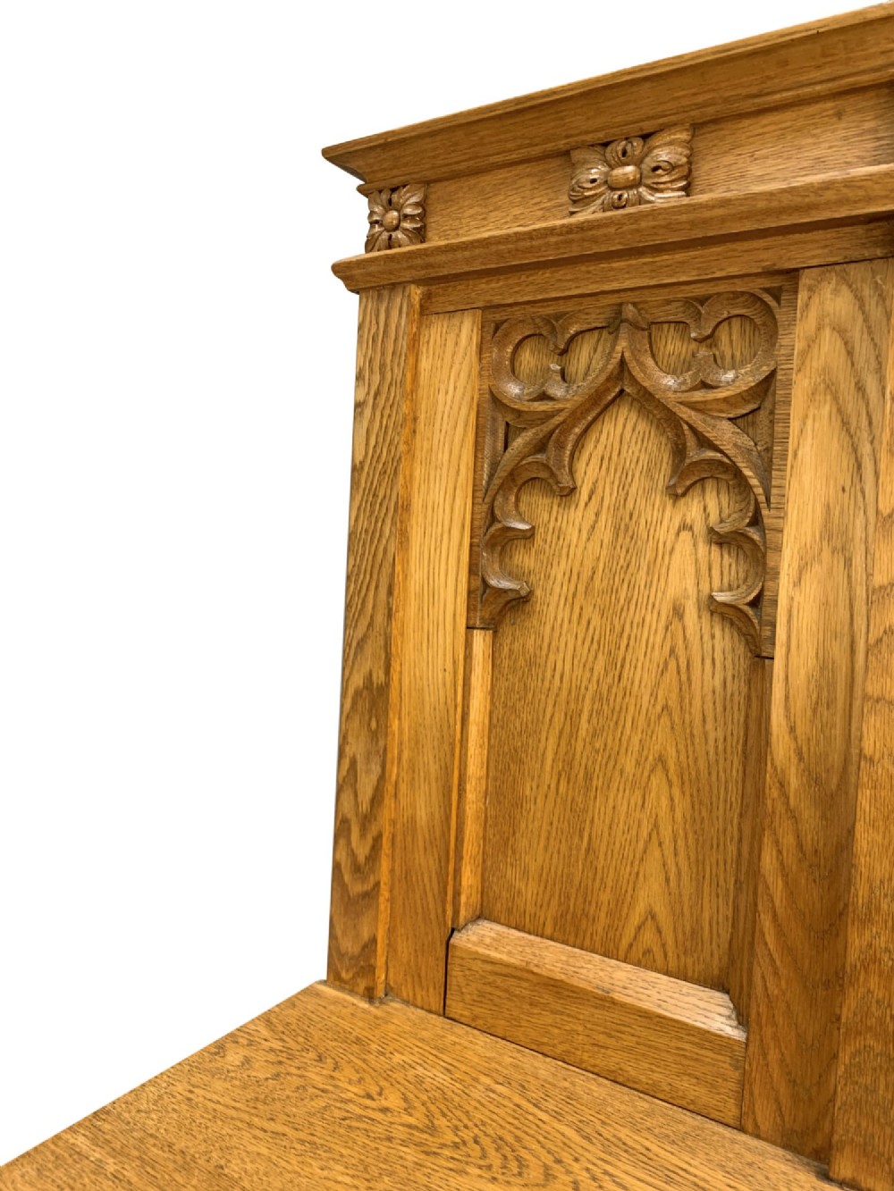 A set of four solid English oak hall chairs featuring carved Gothic arch panels on the backrests, flat solid seats, and straight legs with H-stretchers. View VIII