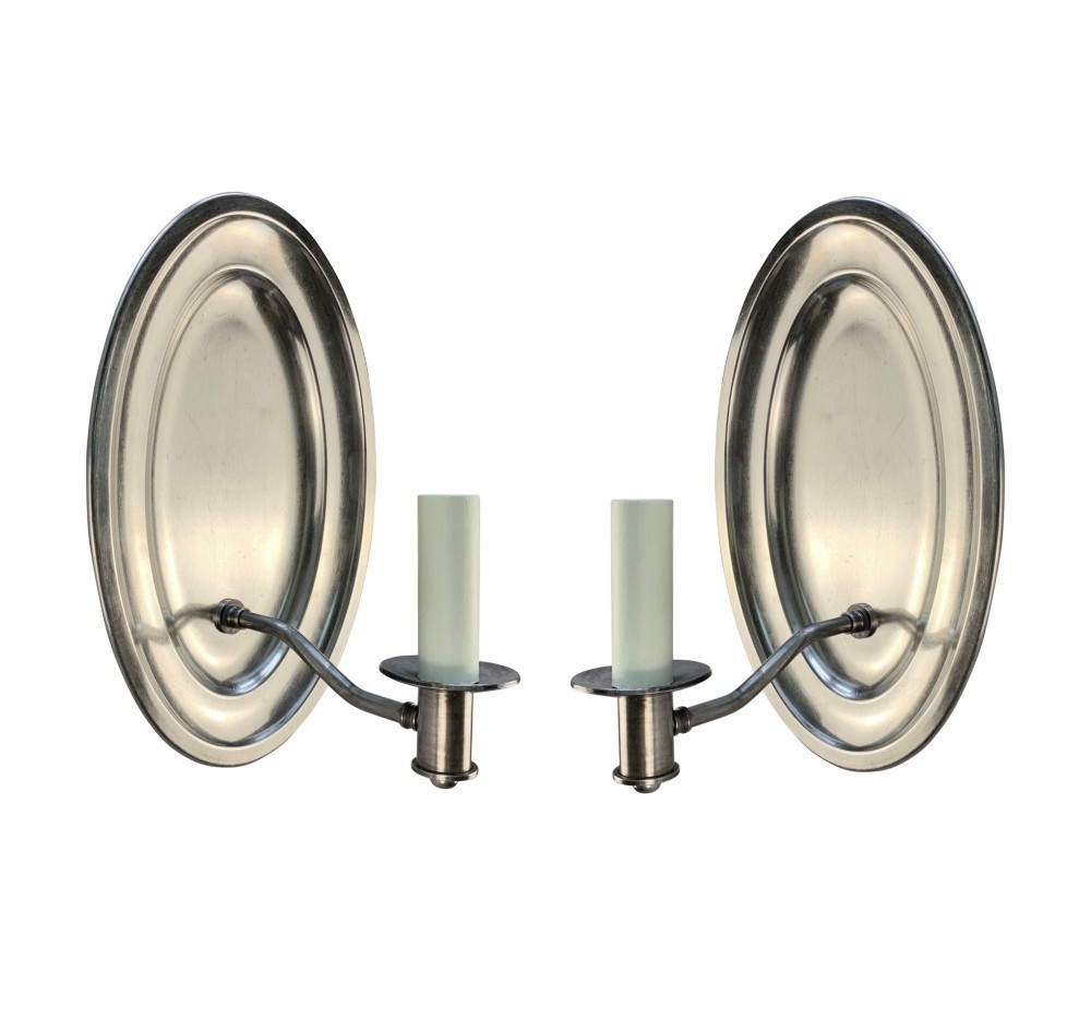 A set of six oval silver-plated single-arm wall sconces featuring reflective backplates and candle-style light sockets. View III