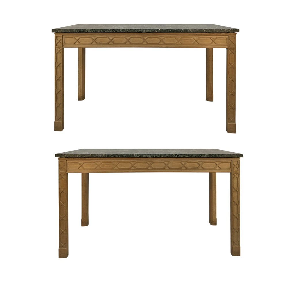 A pair of George III style natural pine console tables featuring carved geometric lattice friezes and dark green marble tops.