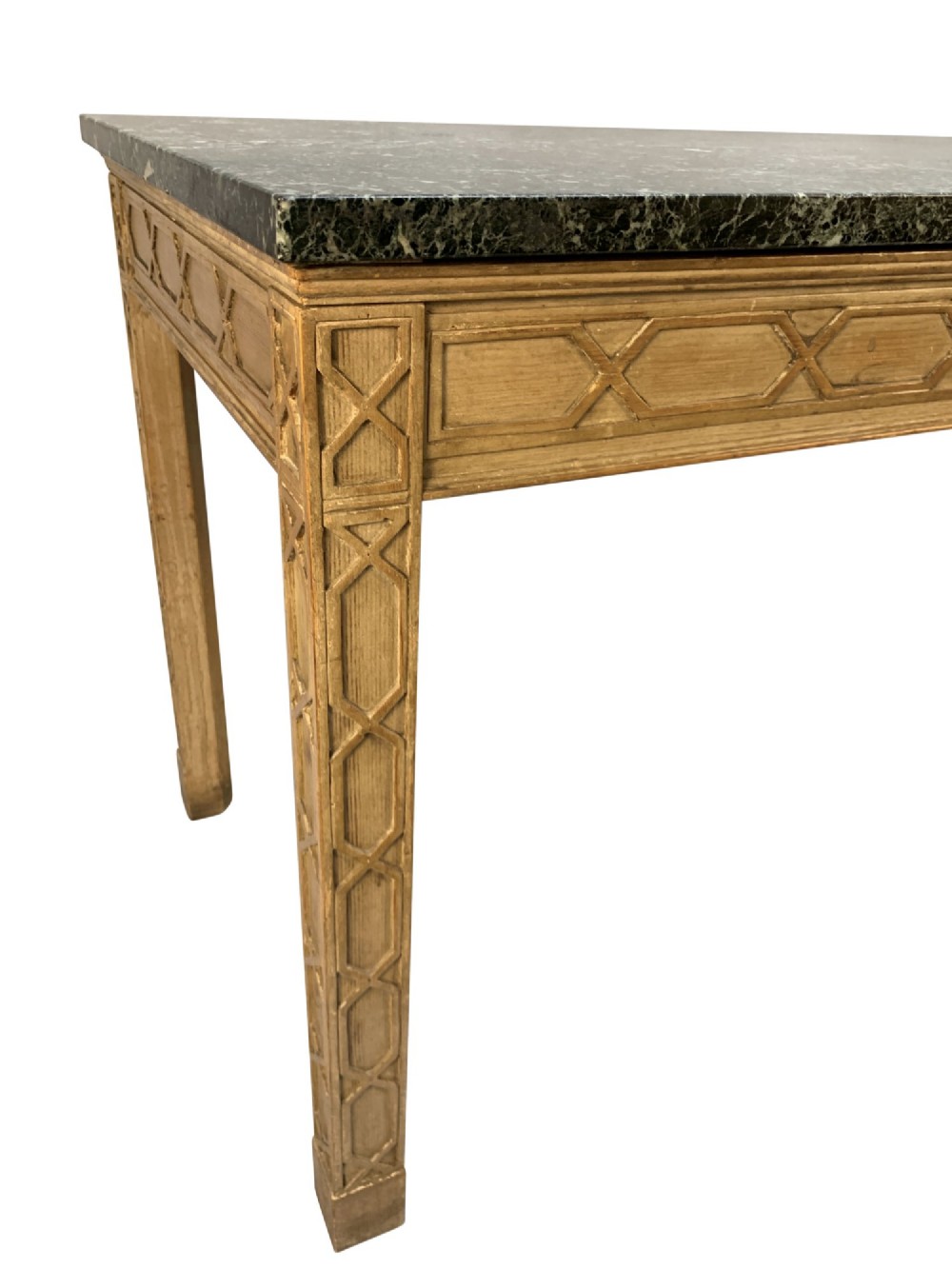 A pair of George III style natural pine console tables featuring carved geometric lattice friezes and dark green marble tops. View VIII