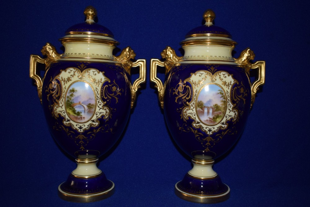 Coalport  pair of hand painted vases and covers