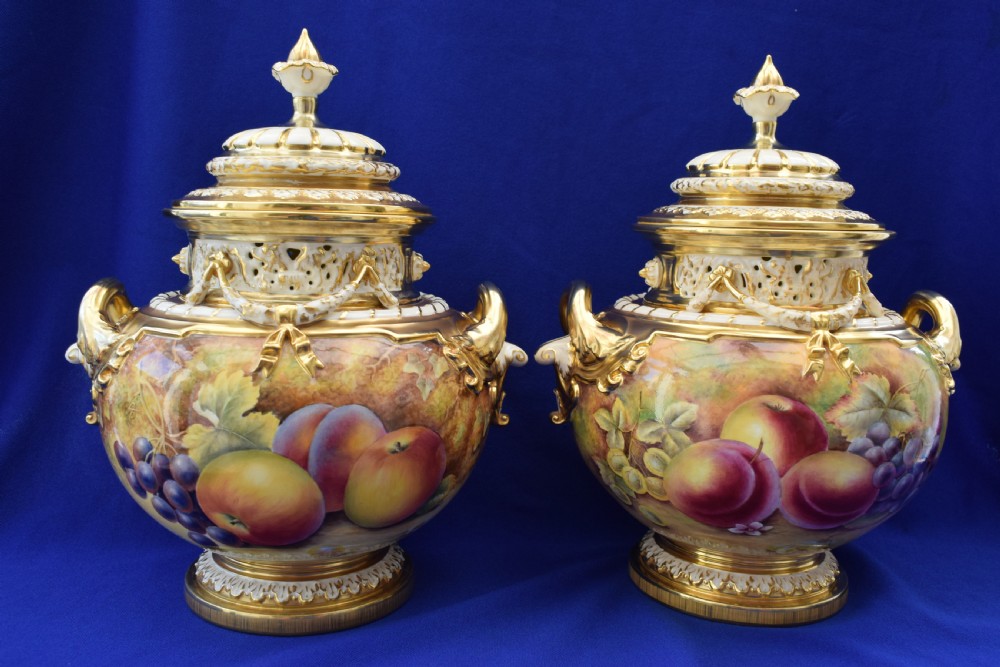 A pair of Royal Worcester painted fruit bow vases and covers