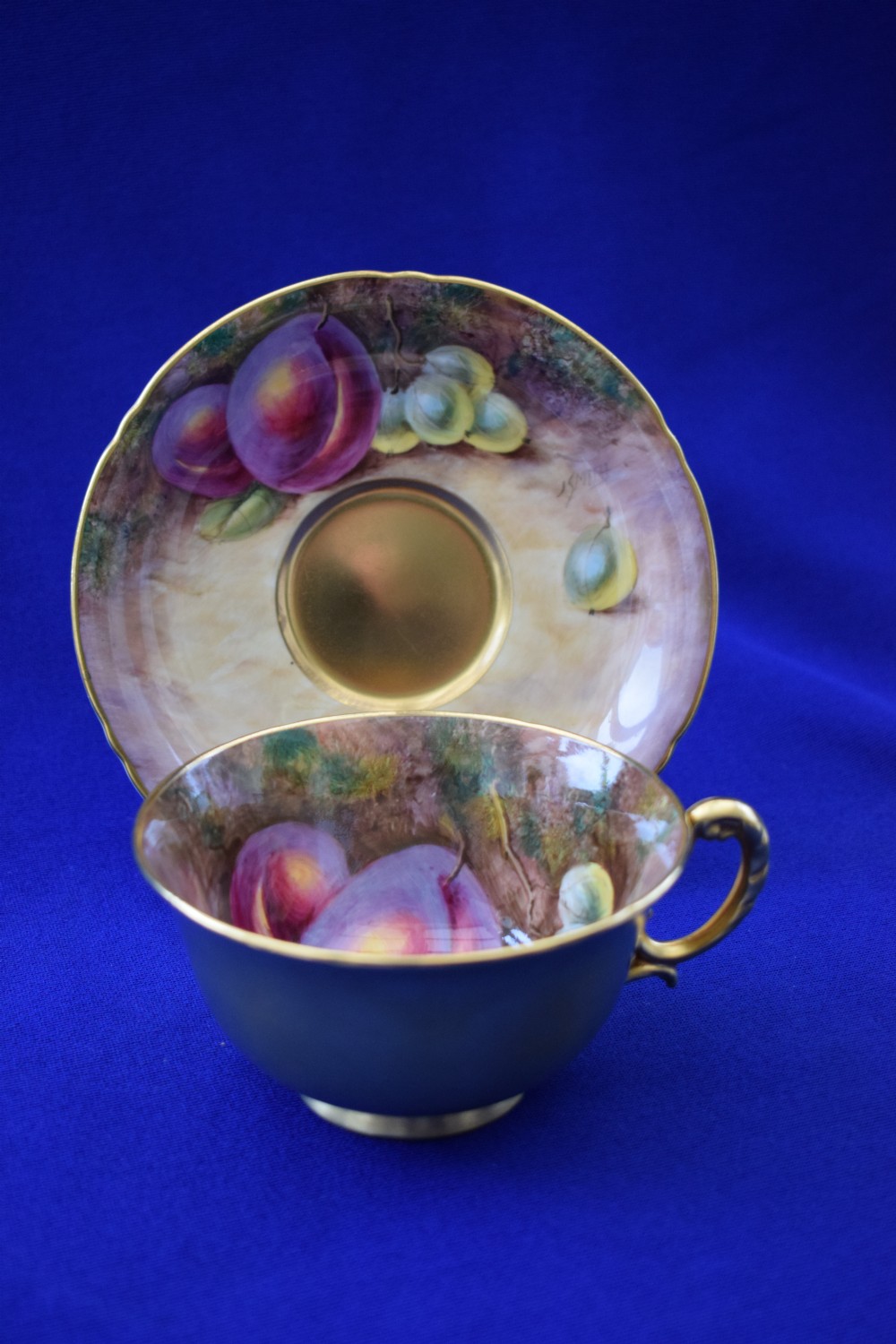 Royal Worcester painted fruit cup and saucer